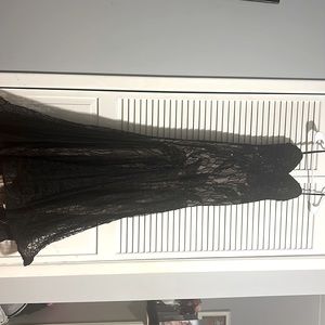 This black black corset that is beaded, snatched waist, mermaid tale.